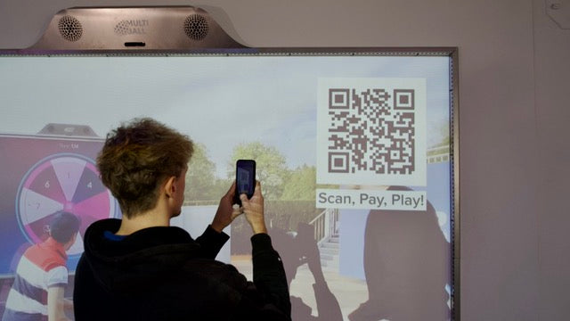 Man using his phone to scan the QR Code of the MultiBall to play