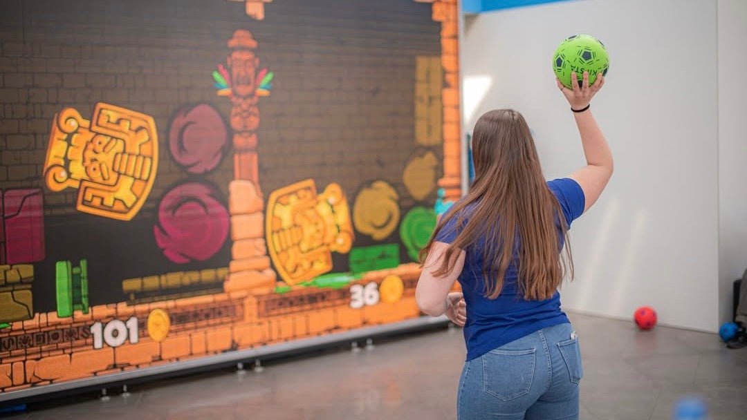 Woman training her handball skills with a MultiBall game