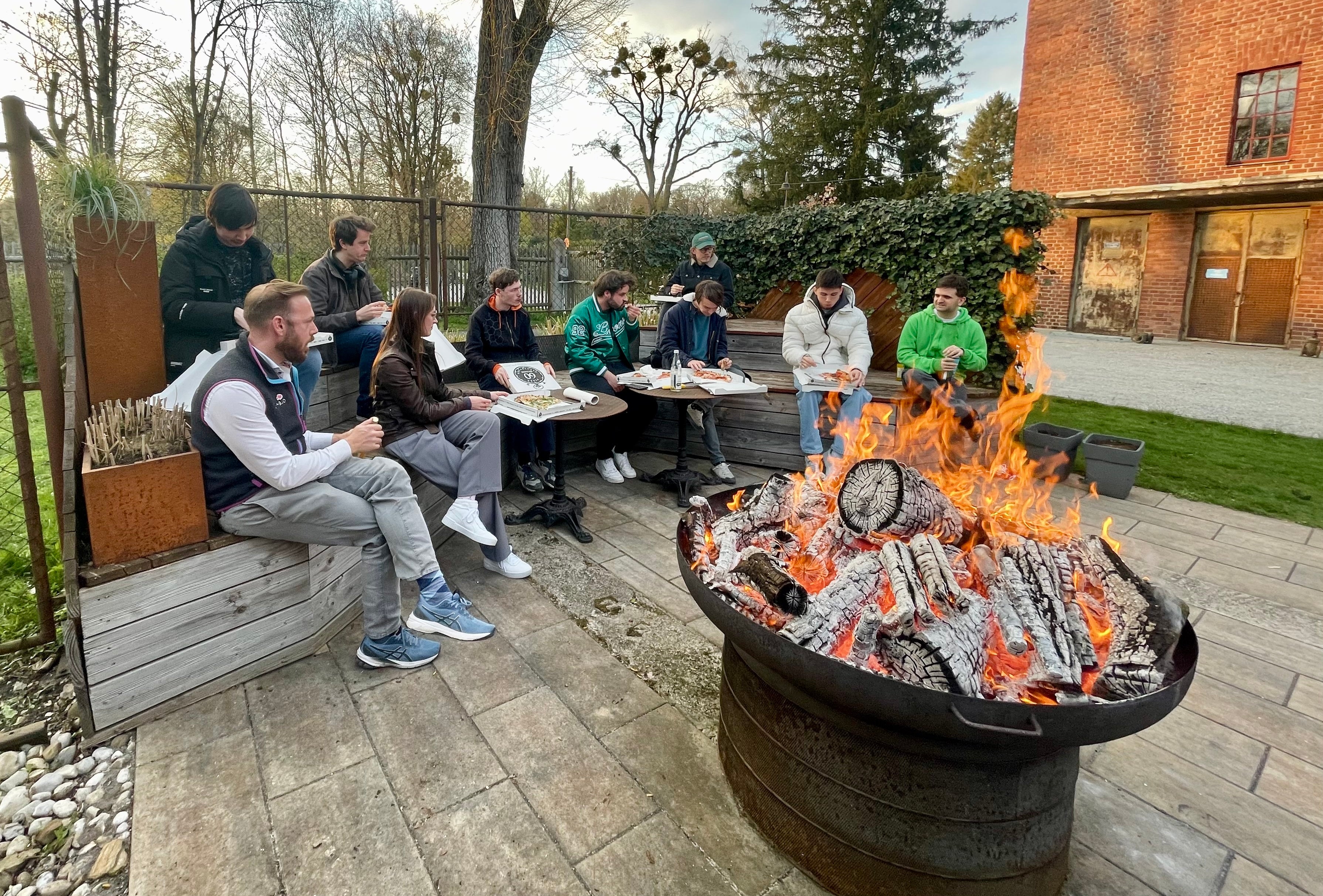 Fire Bowl burning with people eating at BBQ Area for MultiBall PlayRoom Bookings