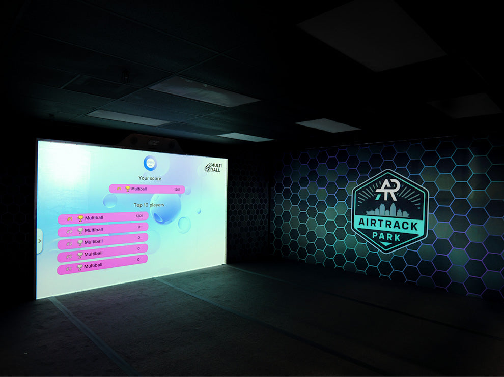 Interactive wall MultiBall displaying the leaderboard in the indoor playground AirTrack Park with their branding on the wall.