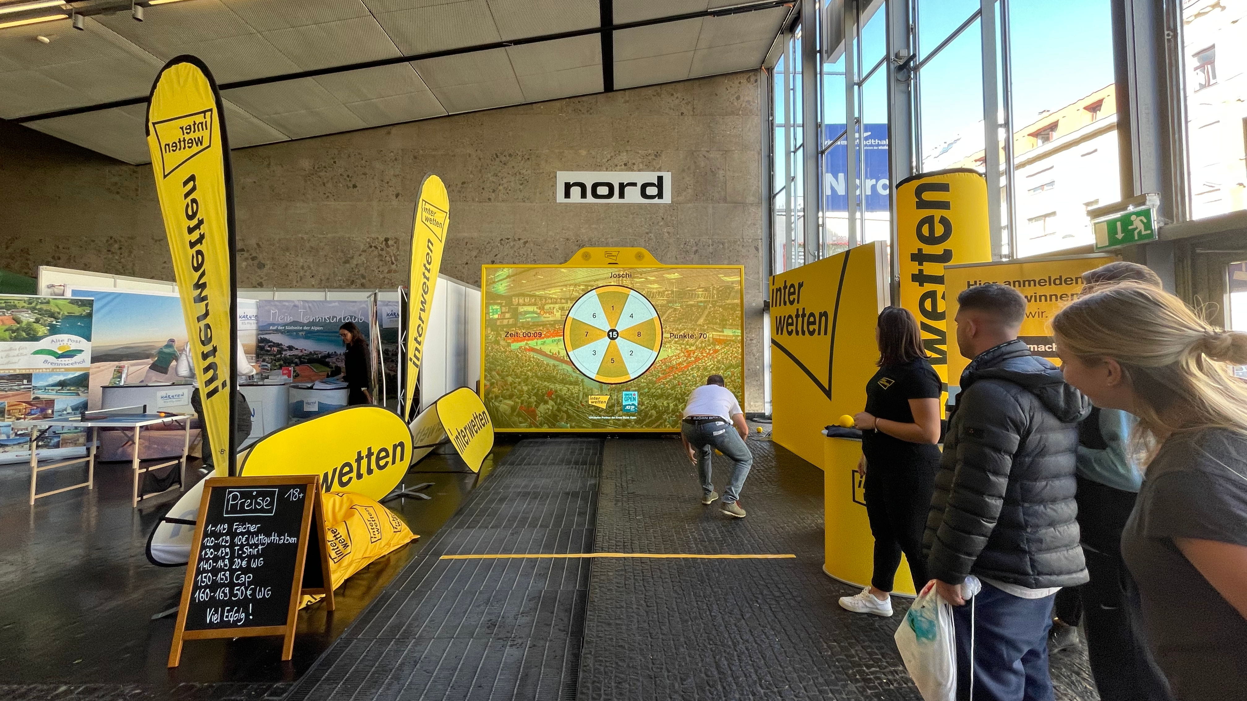 A person playing the game Darts on an interactive MultiBall LED system at the Erste Bank Open in Vienna where MultiBall cooperated with interwetten