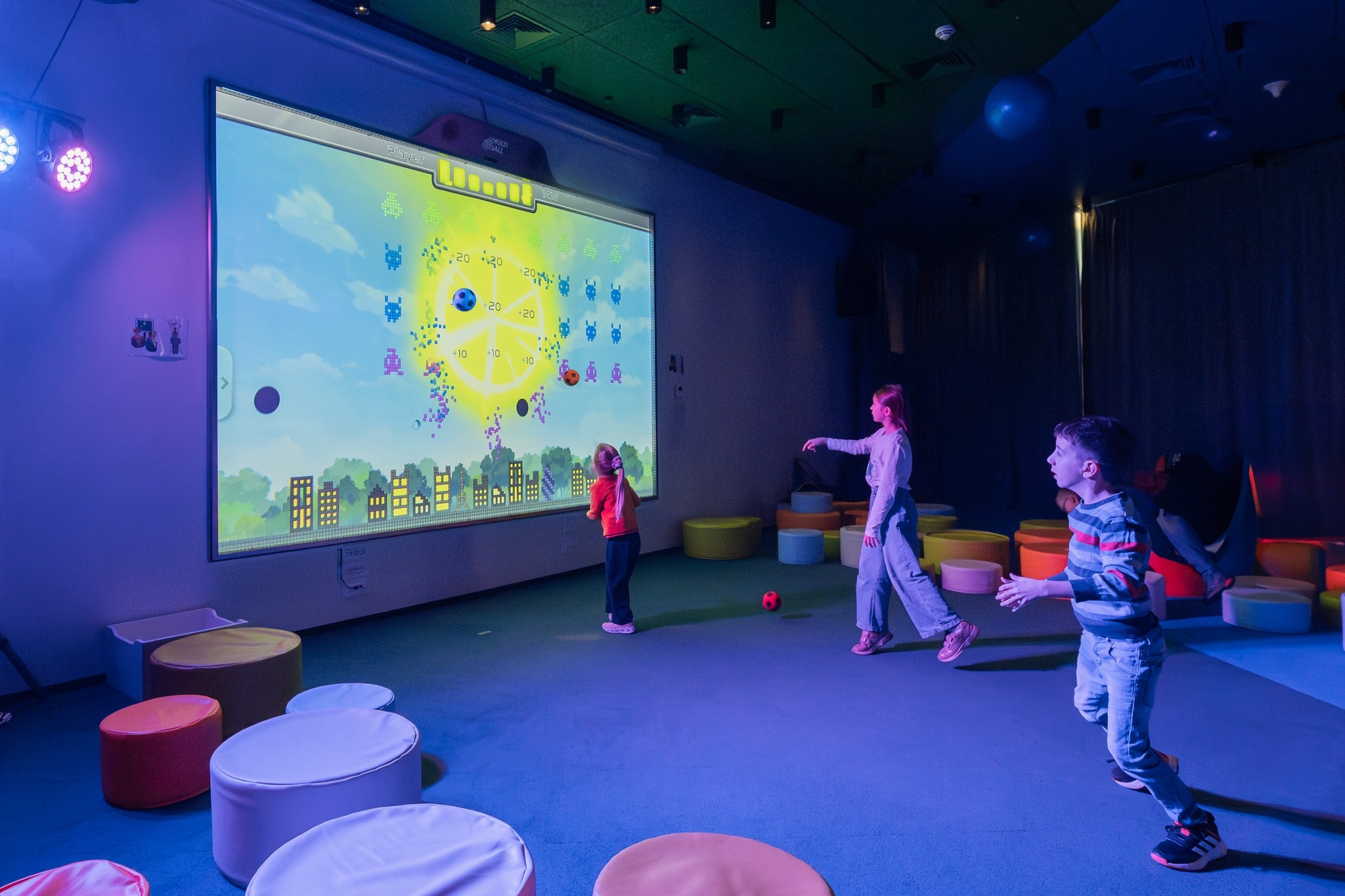 Kids playing on the interactive wall MultiBall by throwing balls in the Hotel Amarin more than 8 hours every day.