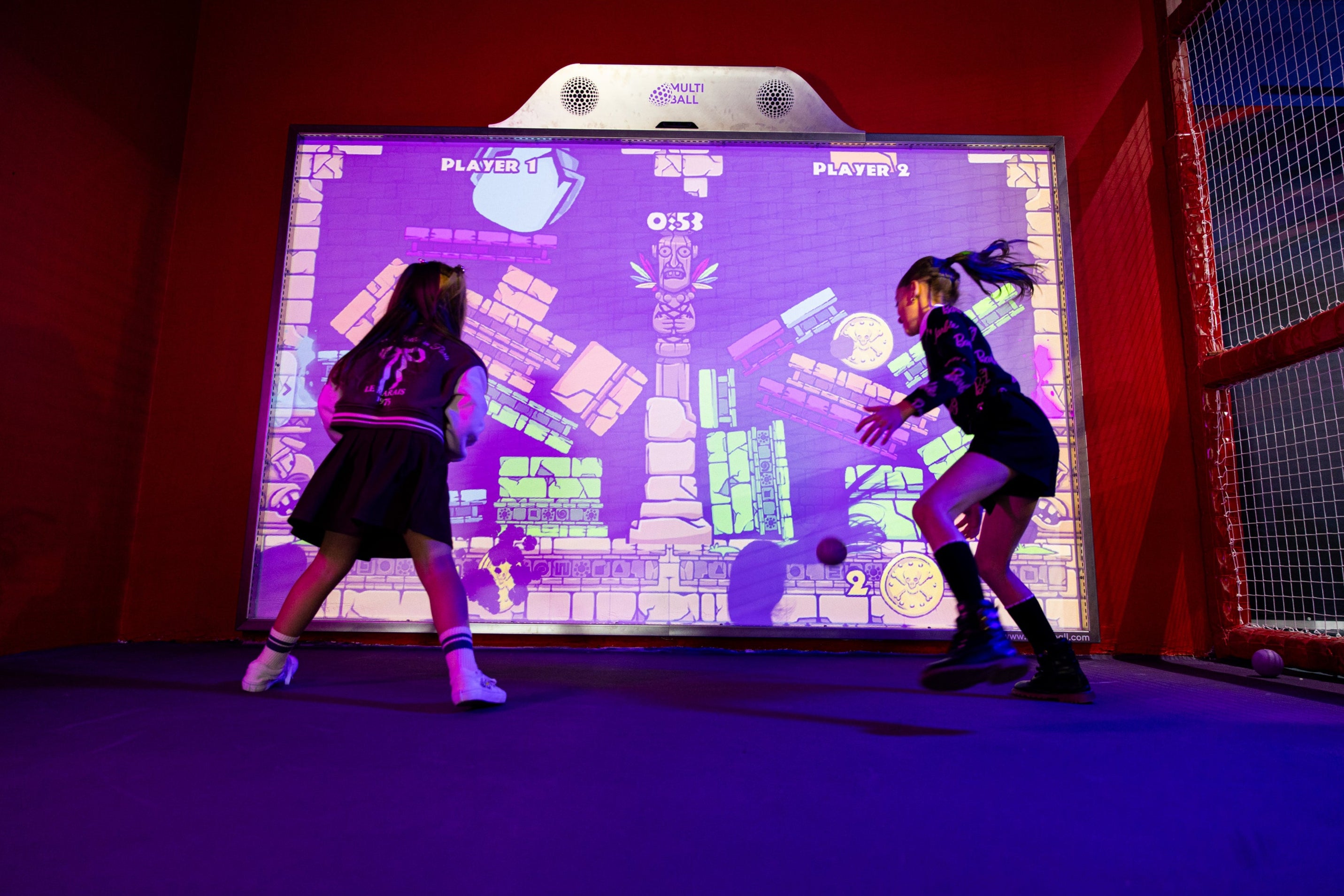 Two children playing the video game Idol Rush on the interactive screen MultiBall in the Kickoff Arena