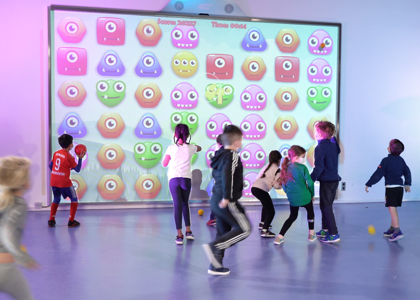 Kids playing the game Monster Match on the interactive wall MultiBall in a school