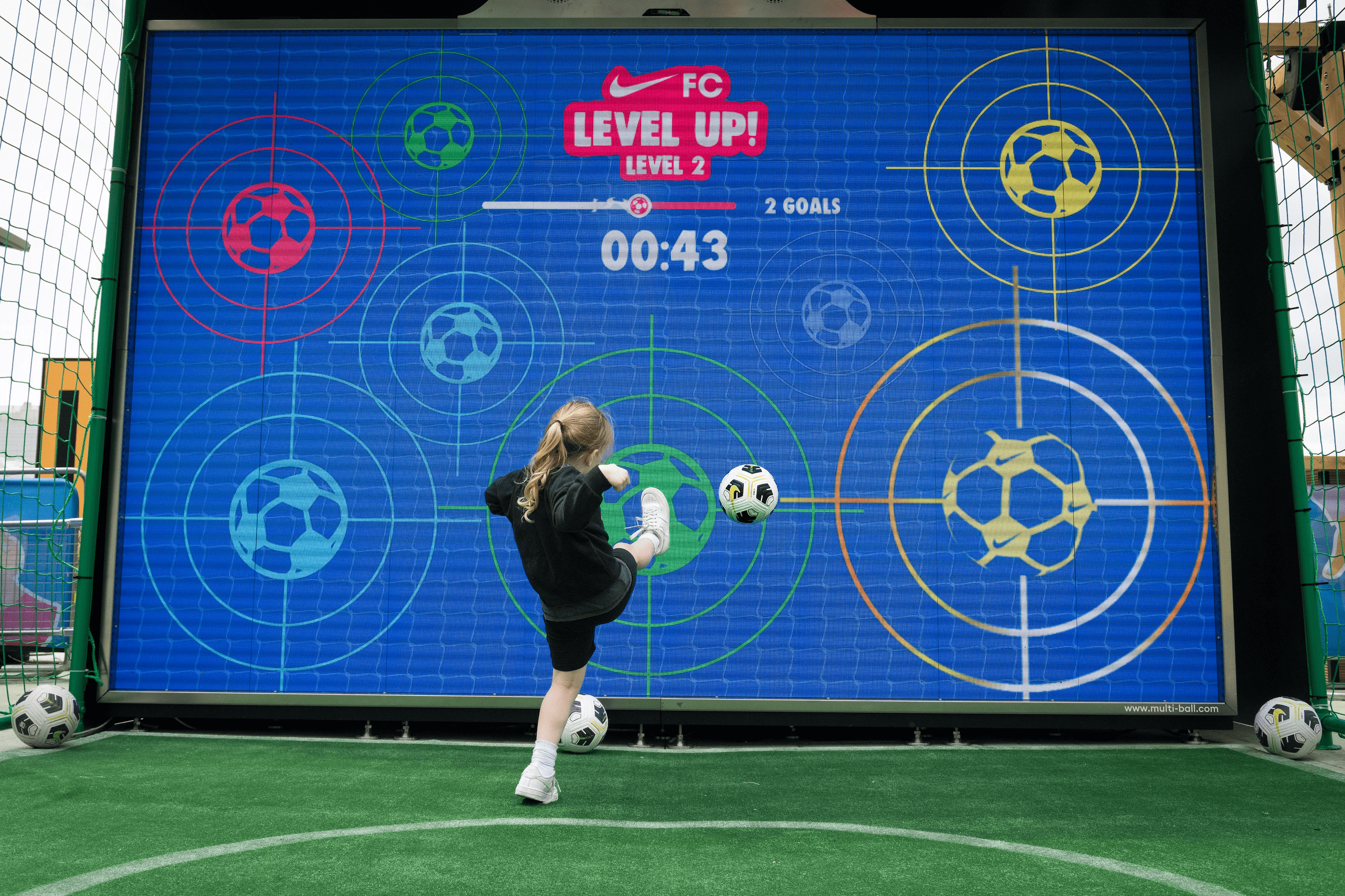 A child playing football on the interactive wall MultiBall at a Nike event