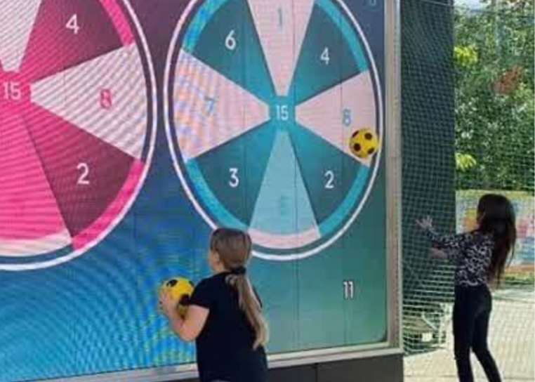 Kids playing the game Darts on the interactive wall MultiBall