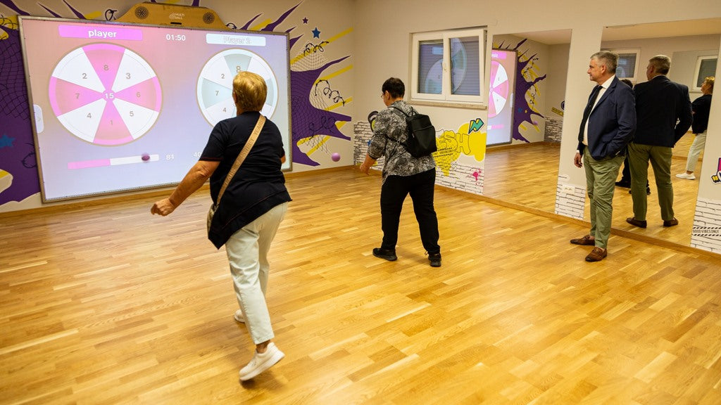 Seniors training with the Darts game on the interactive sport wall MultiBall at the fitness center Sveti Petar u Šumi