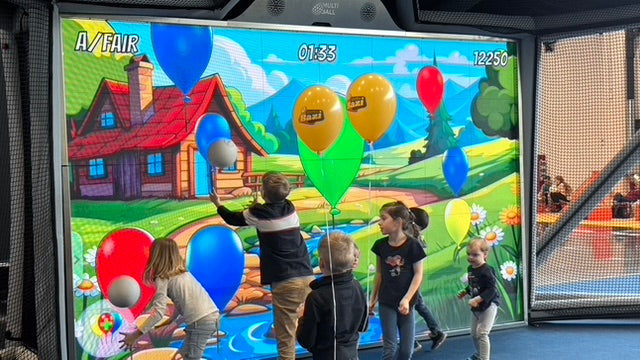 Kids playing the game Balloon Mania on the MultiBall system