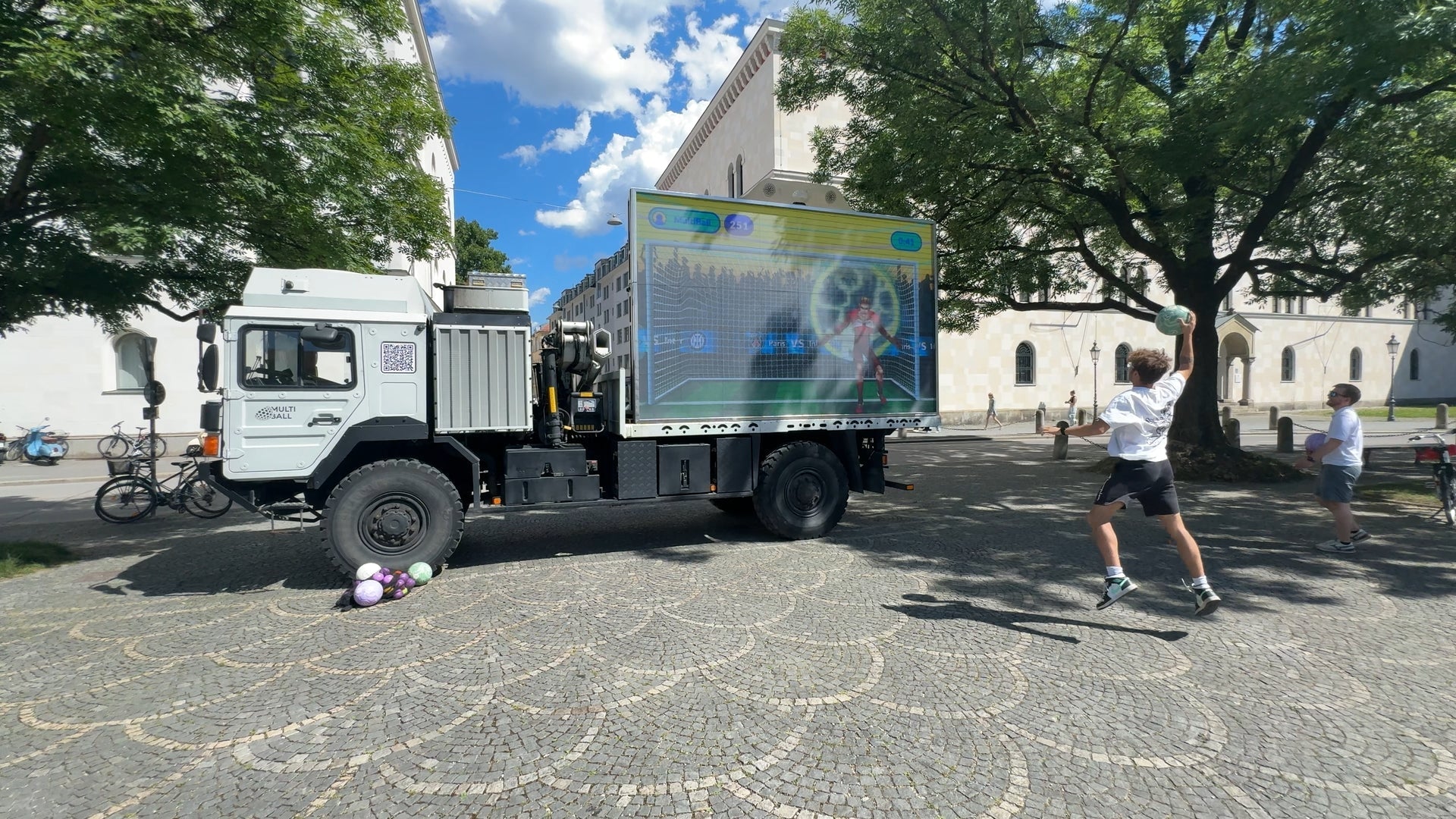 Man jumps while throwing a ball at the MultiBall LED Truck system.