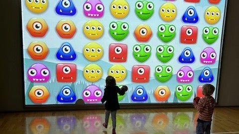 Kids standing in front of a MultiBall system playing Monster Mash