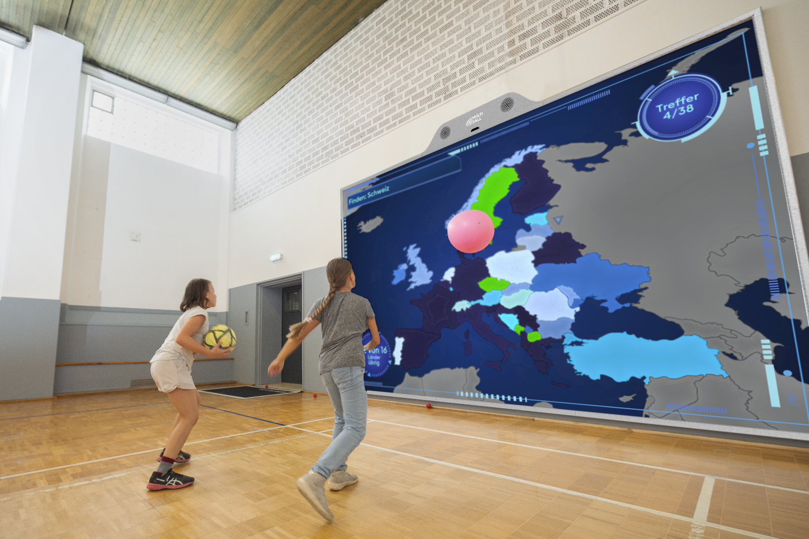 Two girls playing the education game Countries on a interactive MultiBall wall in a School in Munich
