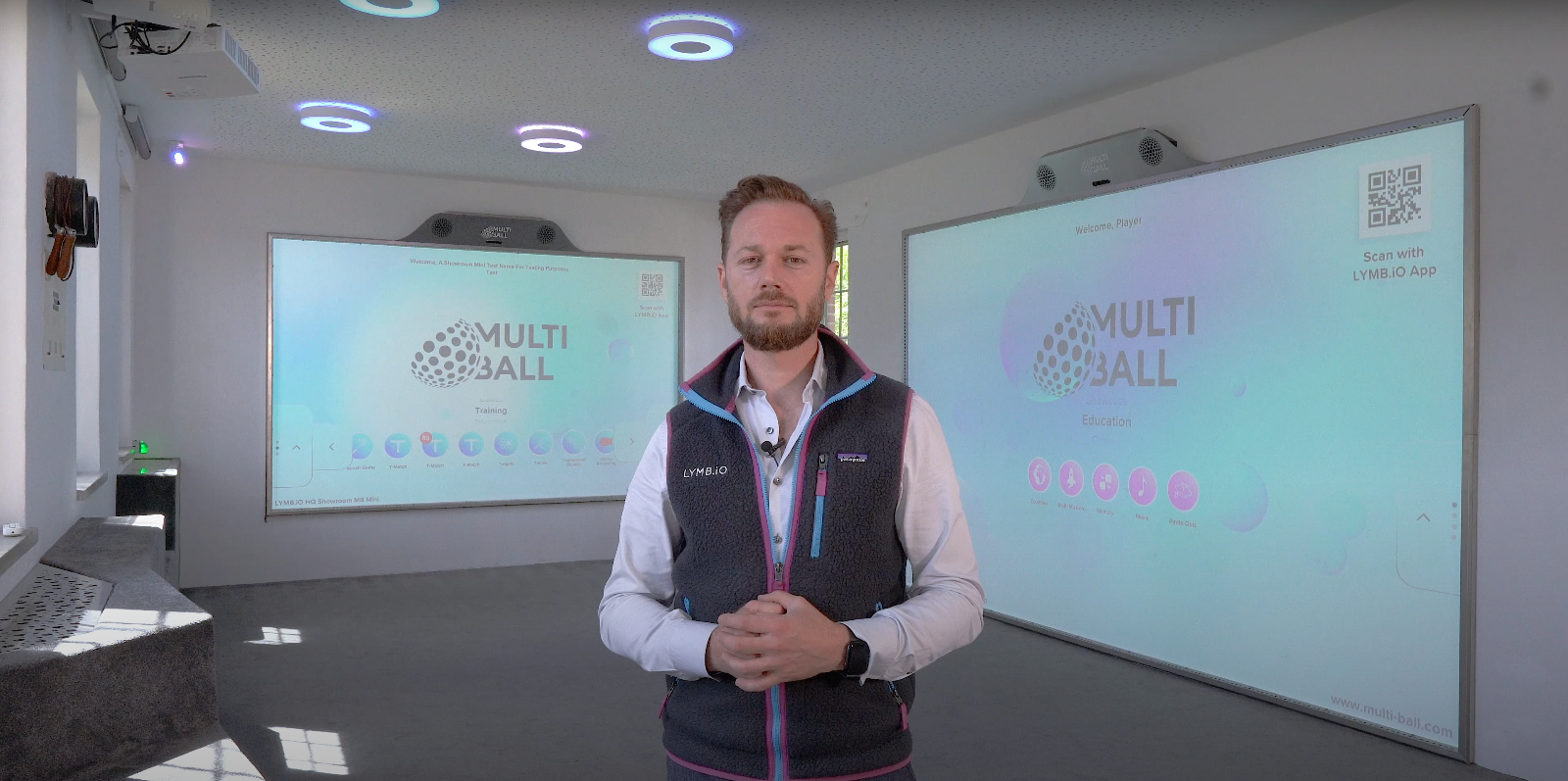 Markos standing in Playroom 1 in front of two interactive Multiall walls