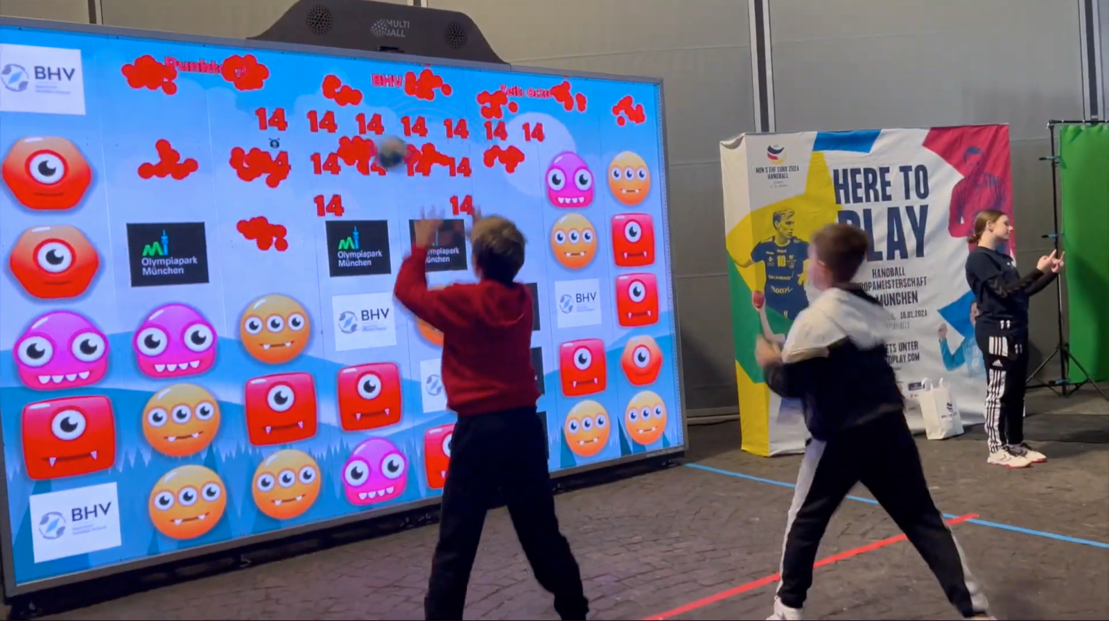 Kids playing the game Monster Match on the interactive wall MultiBall