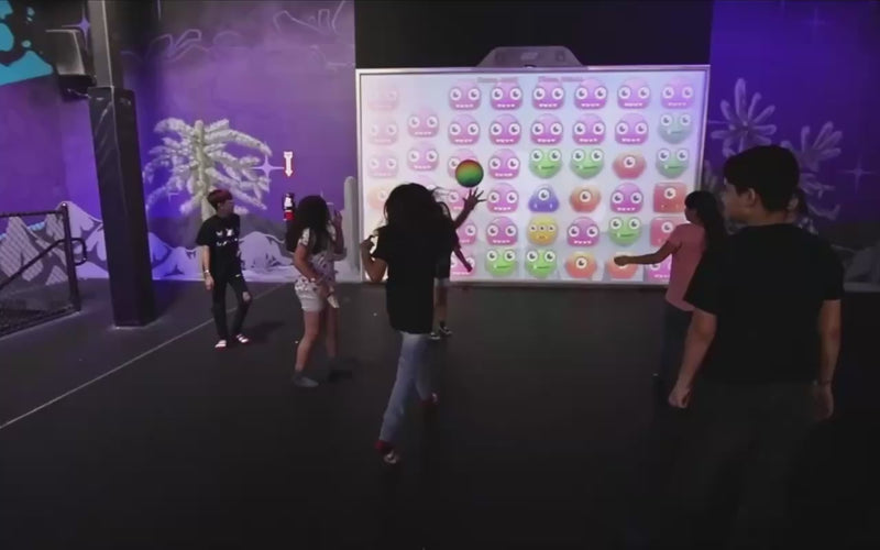 A lot of people of every age group playing games on interactive MultiBall walls at different events and occasions 