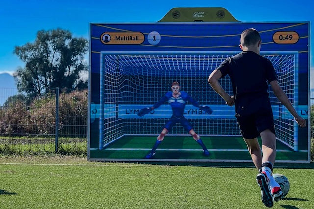 A kid playing soccer on the interactive wall MultiBall in the training game Goal 3D